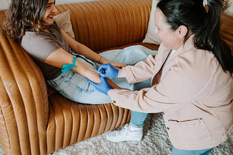 Mobile IV therapy in Harbor City, CA by Lively Drops, a nurse placing an IV line in a seated client's arm
